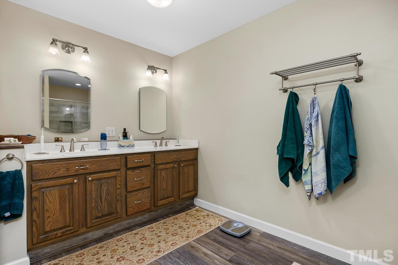 1008 Windstar Way Willow Spring, NC 27592 - Photo 19 of 51 a bathroom with a double vanity sink and a mirror