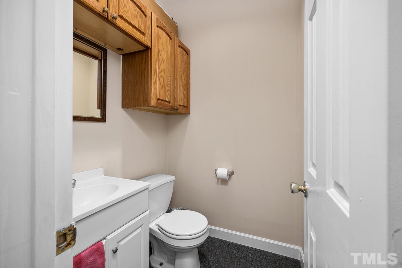 1008 Windstar Way Willow Spring, NC 27592 - Photo 26 of 51 a white toilet sitting next to a bathroom sink