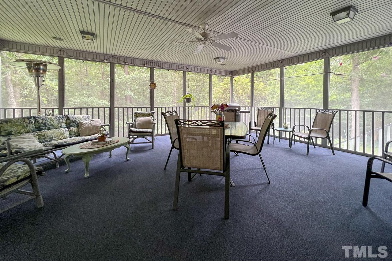 1008 Windstar Way Willow Spring, NC 27592 - Photo 27 of 51 a living room with furniture and a floor to ceiling window