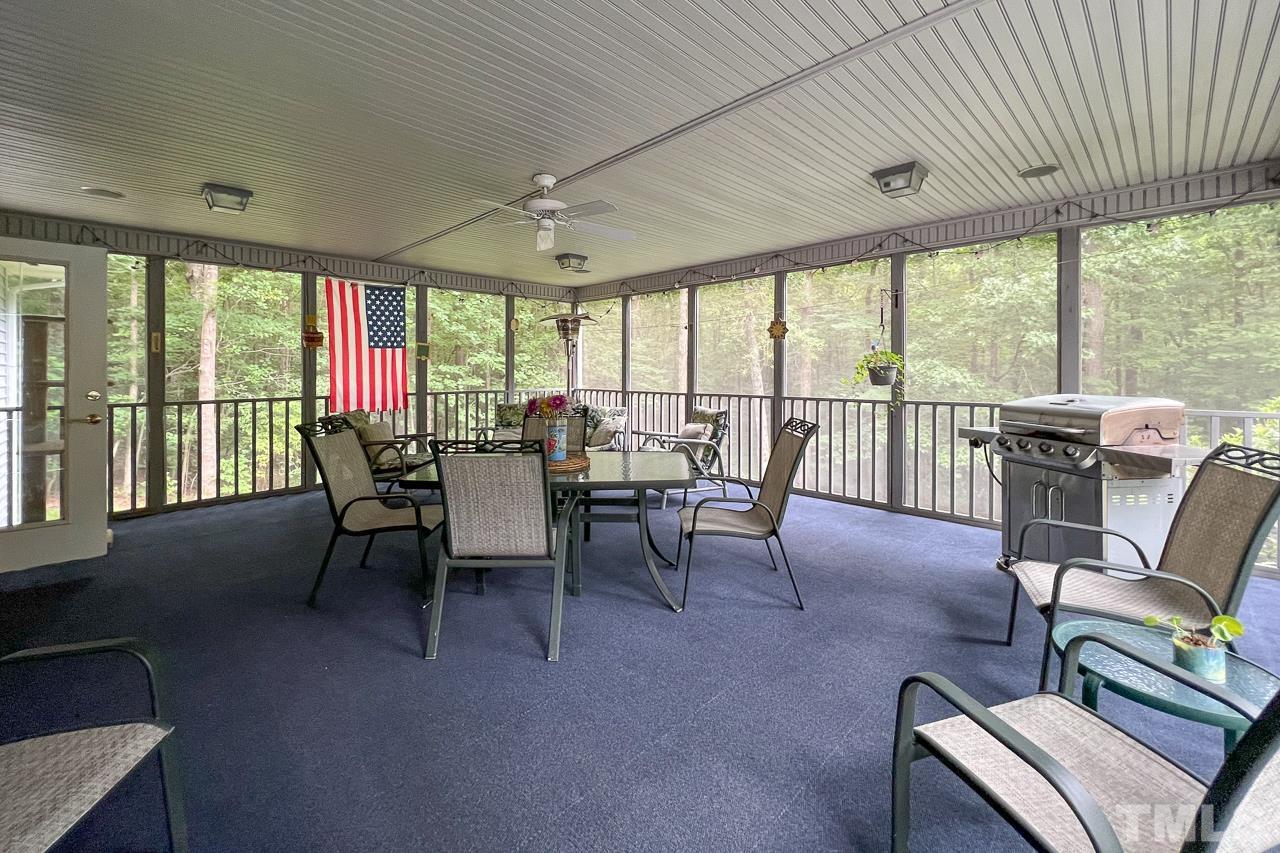 1008 Windstar Way Willow Spring, NC 27592 - Photo 28 of 51 a view of a dining room with furniture large windows and wooden floor