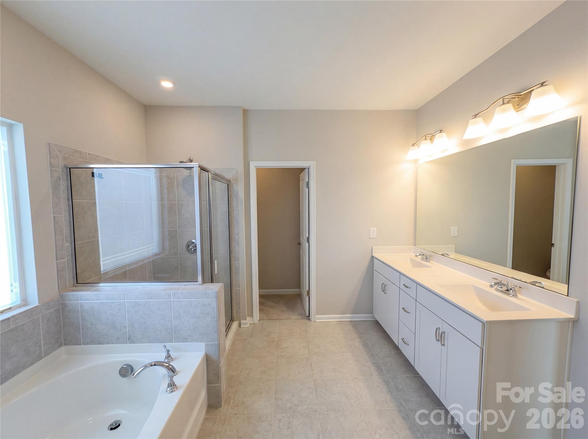 617 Ardsley Drive Locust, NC 28097 - Photo 13 of 23 a bathroom with a tub a sink and mirrors