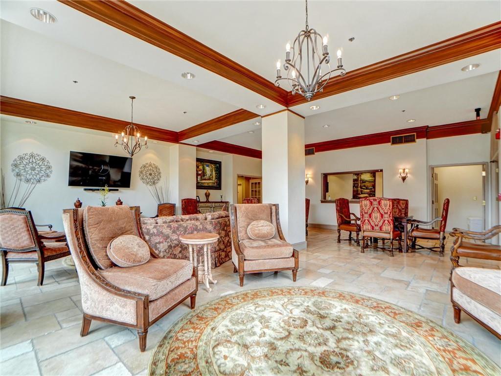 3435 Kingsboro Road Northeast, Unit 1601 Atlanta, GA 30326 - Photo 51 of 54 a living room with furniture a dining table and a fireplace