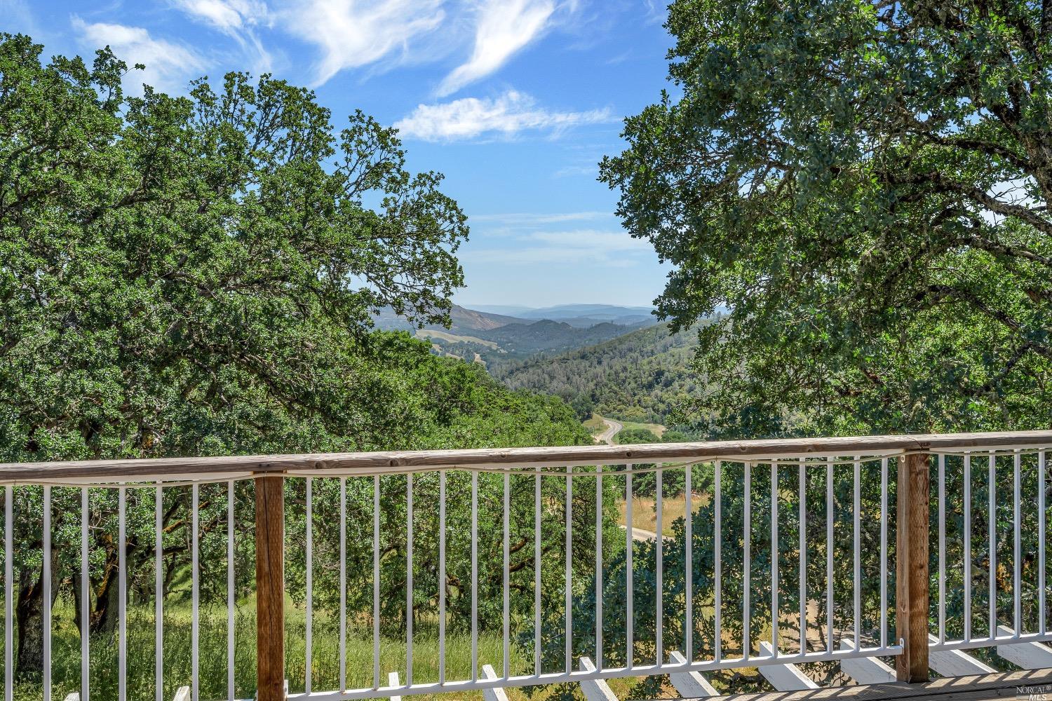 19511 Oak Haven Road Lower Lake, CA 95457 - Photo 13 of 39 a view of a balcony with wooden floor and fence