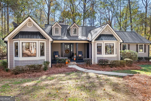 a front view of a house with sitting area and porch