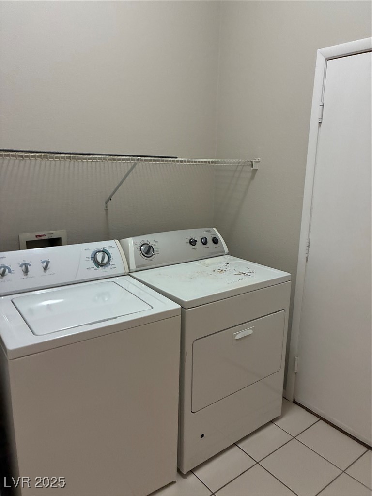3346 Wasatch Cedars Street Las Vegas, NV 89122 - Photo 7 of 9 Laundry room featuring light tile patterned floors and washing machine and dryer