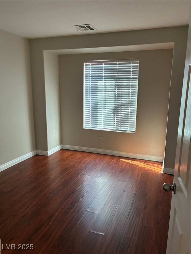 3346 Wasatch Cedars Street Las Vegas, NV 89122 - Photo 8 of 9 Unfurnished room with baseboards and wood finished floors