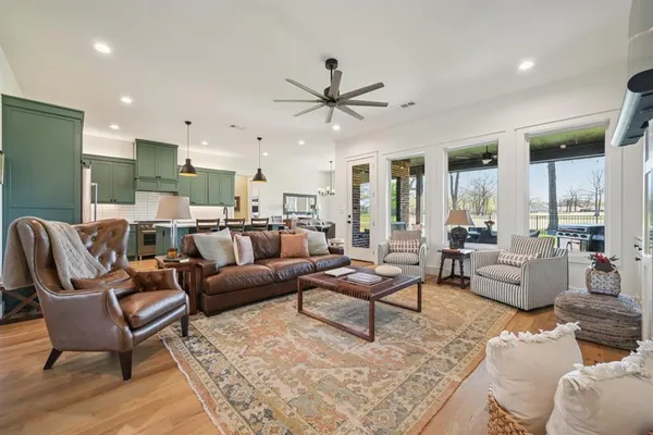 a large kitchen with stainless steel appliances granite countertop a sink and cabinets