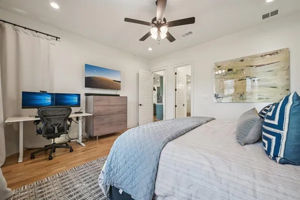 a bathroom with a granite countertop toilet sink and mirror