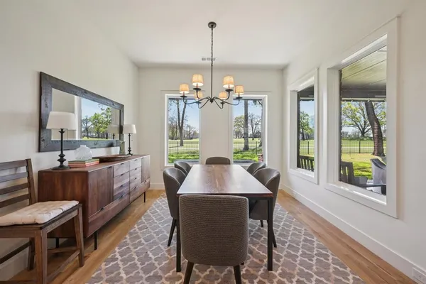 a living room with furniture and a view of kitchen