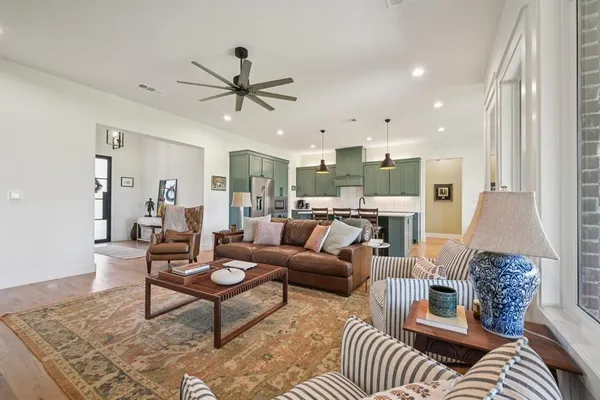 a living room with furniture a fireplace and a flat screen tv