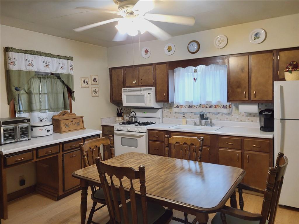 107 Wendel Road Herminie, PA 15637 - Photo 7 of 16 a kitchen with a table chairs sink and cabinets