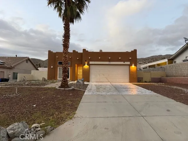 a view of a house with backyard and parking space