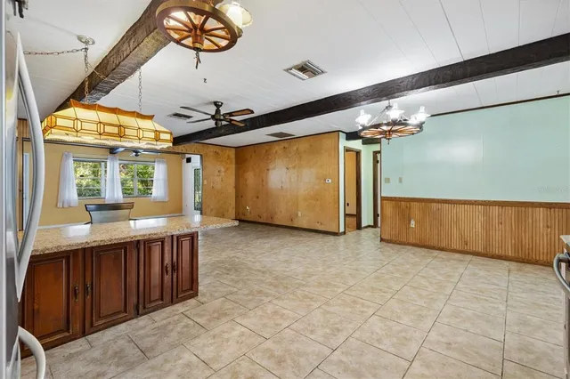 a view of a kitchen with a sink and refrigerator