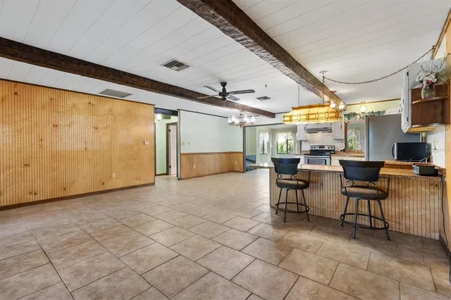 a kitchen with stainless steel appliances granite countertop a sink a stove and a refrigerator