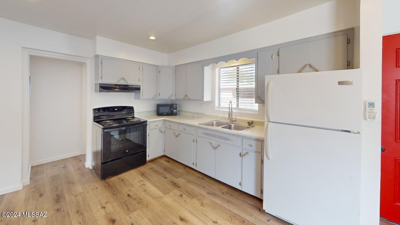 2118 North Rita Avenue Tucson, AZ 85716 - Photo 4 of 17 a kitchen with a refrigerator stove and sink