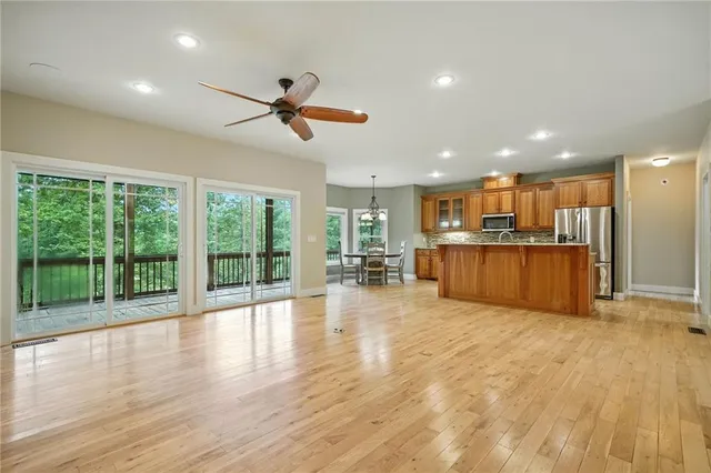a kitchen with stainless steel appliances granite countertop a sink and a window