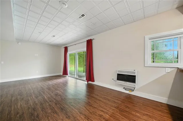 a backyard of a house with lots of green space and a lake view