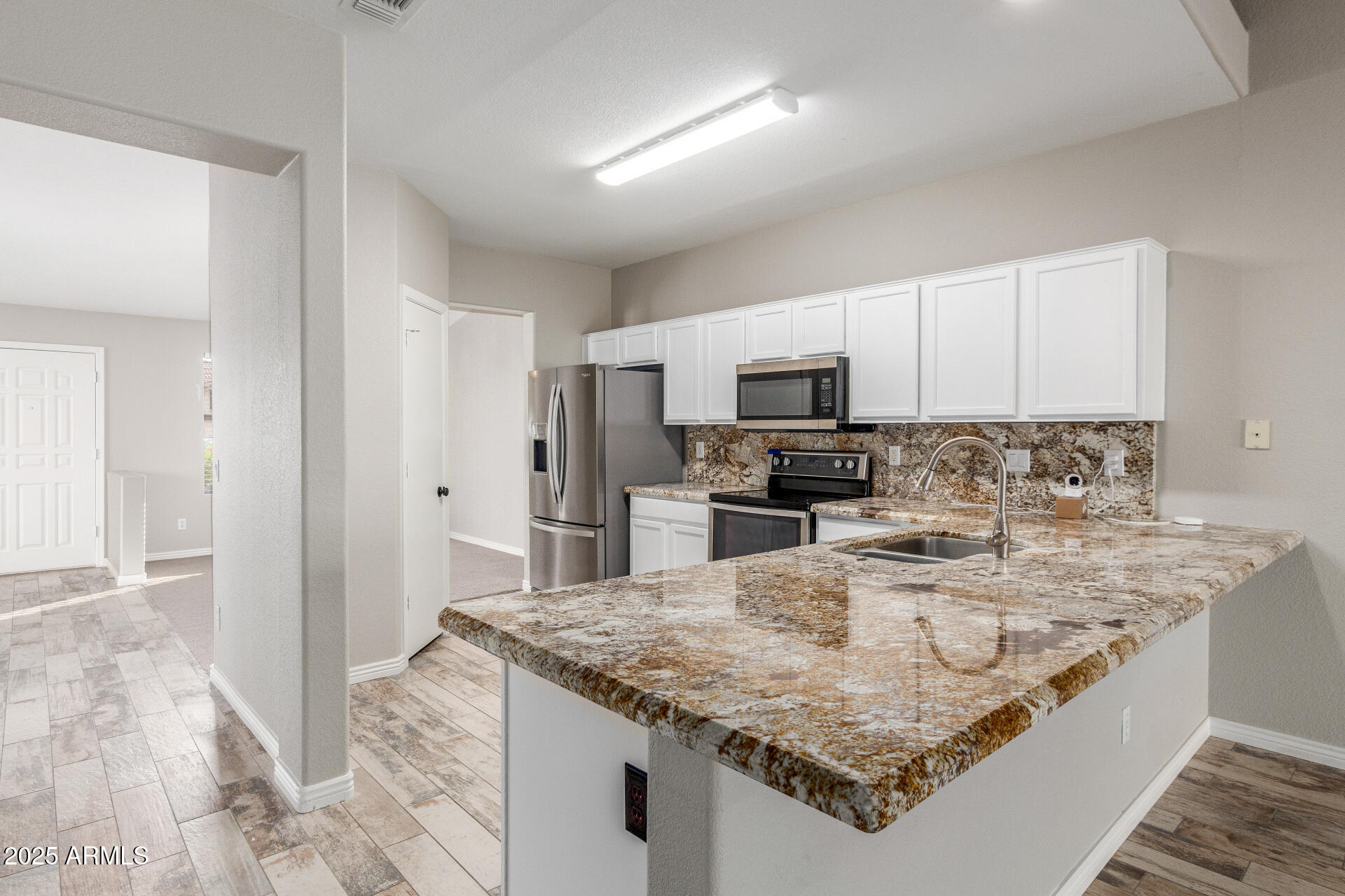11232 East Dover Street Mesa, AZ 85207 - Photo 12 of 31 a kitchen with stainless steel appliances granite countertop a sink stove and refrigerator