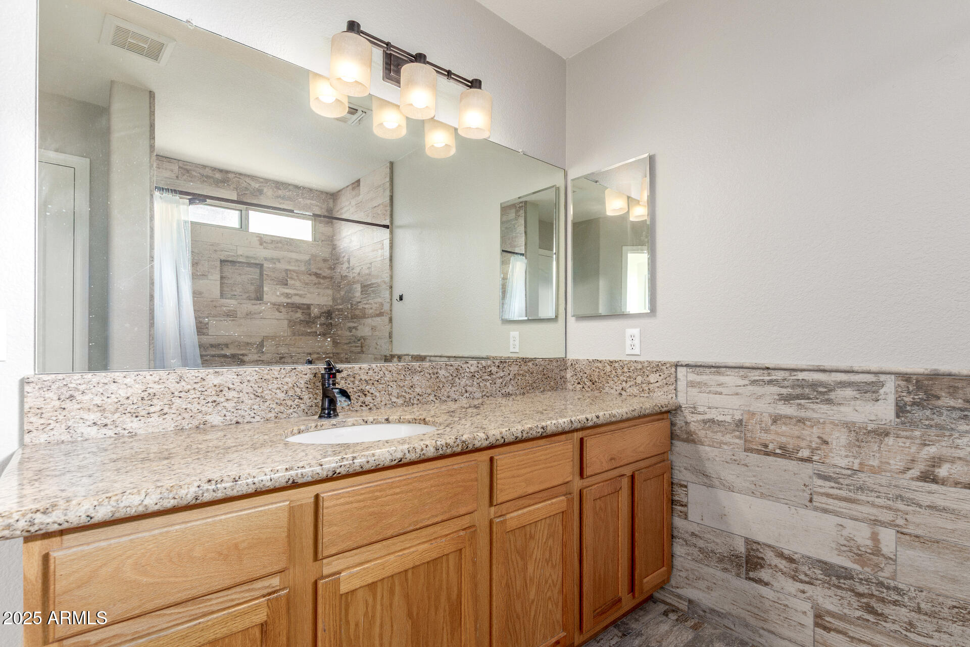 11232 East Dover Street Mesa, AZ 85207 - Photo 19 of 31 a bathroom with a granite countertop sink a mirror and a shower
