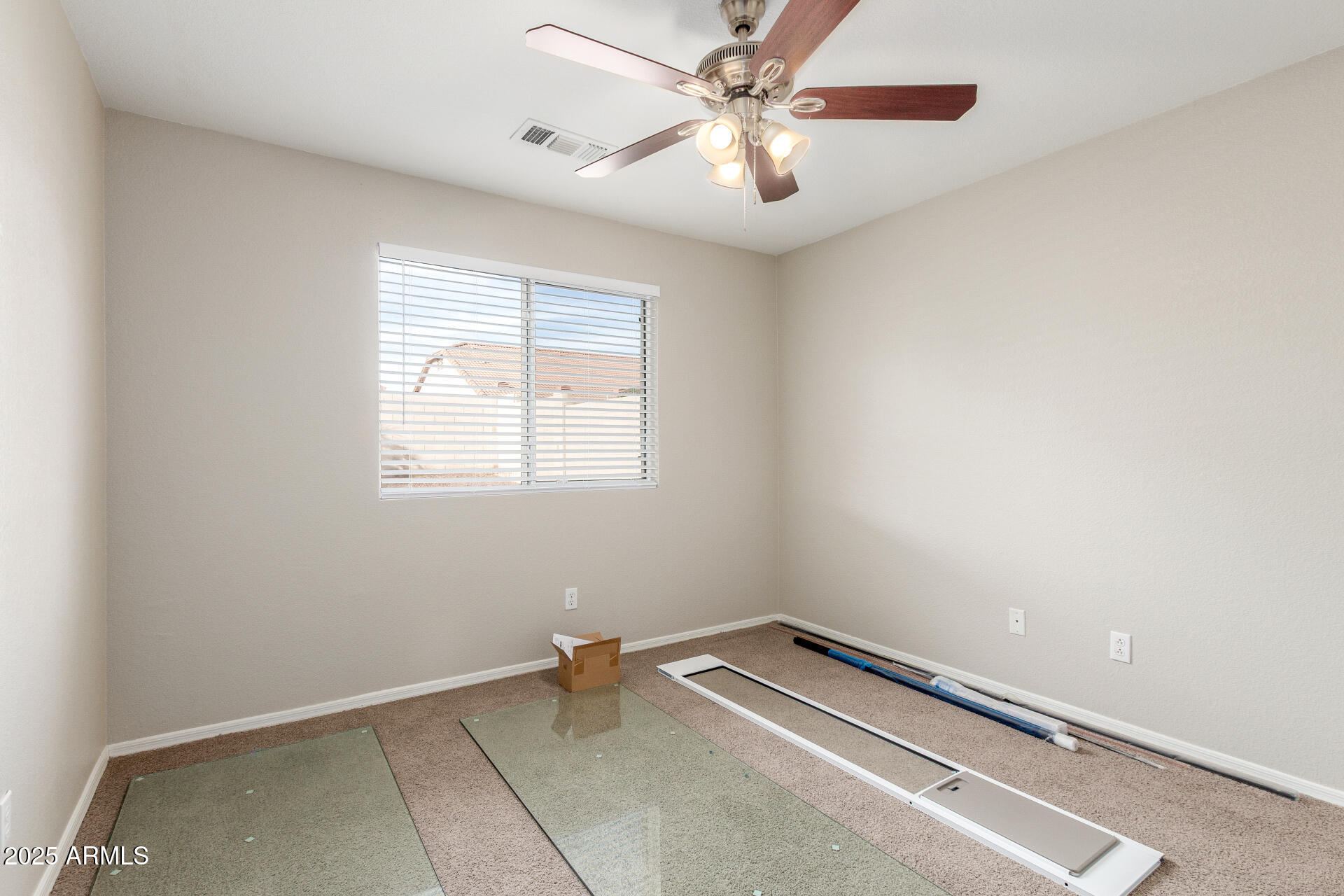 11232 East Dover Street Mesa, AZ 85207 - Photo 21 of 31 an empty room with a chandelier fan and windows