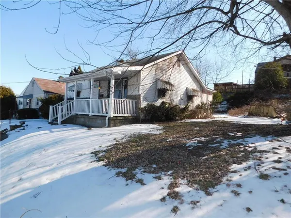 a view of a house with a snow in the yard