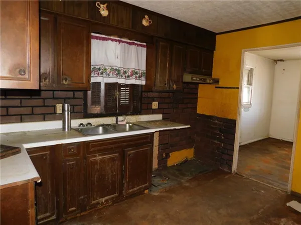 a kitchen with sink and cabinets