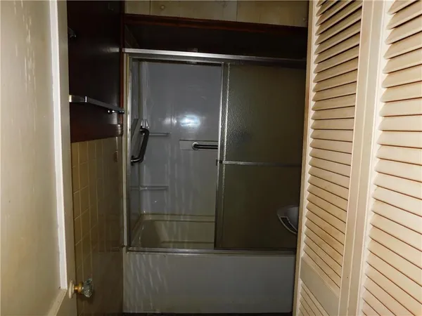 a bathroom with a glass shower door