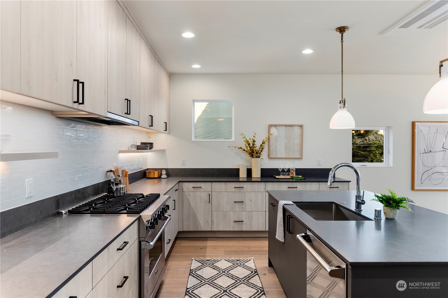 2308 North 38th Street Seattle, WA 98103 - Photo 7 of 40 a kitchen with stainless steel appliances a sink stove and cabinets