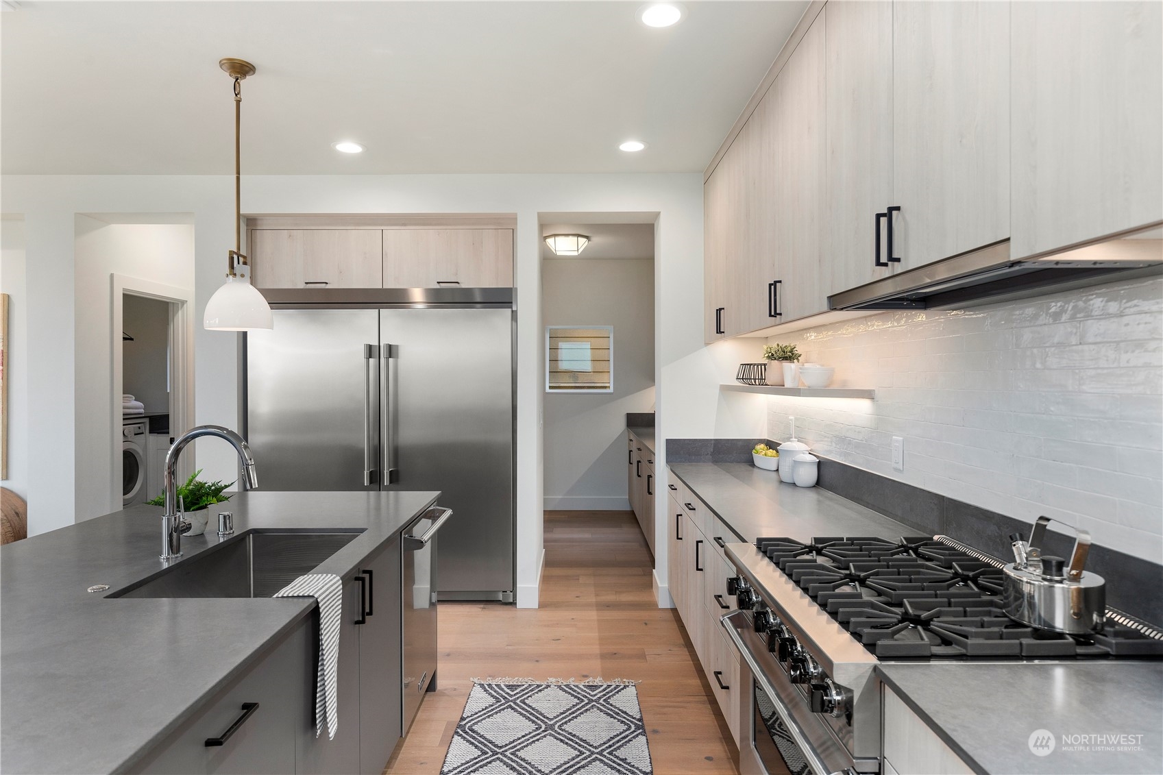 2308 North 38th Street Seattle, WA 98103 - Photo 8 of 40 a kitchen with stainless steel appliances granite countertop a sink stove and refrigerator