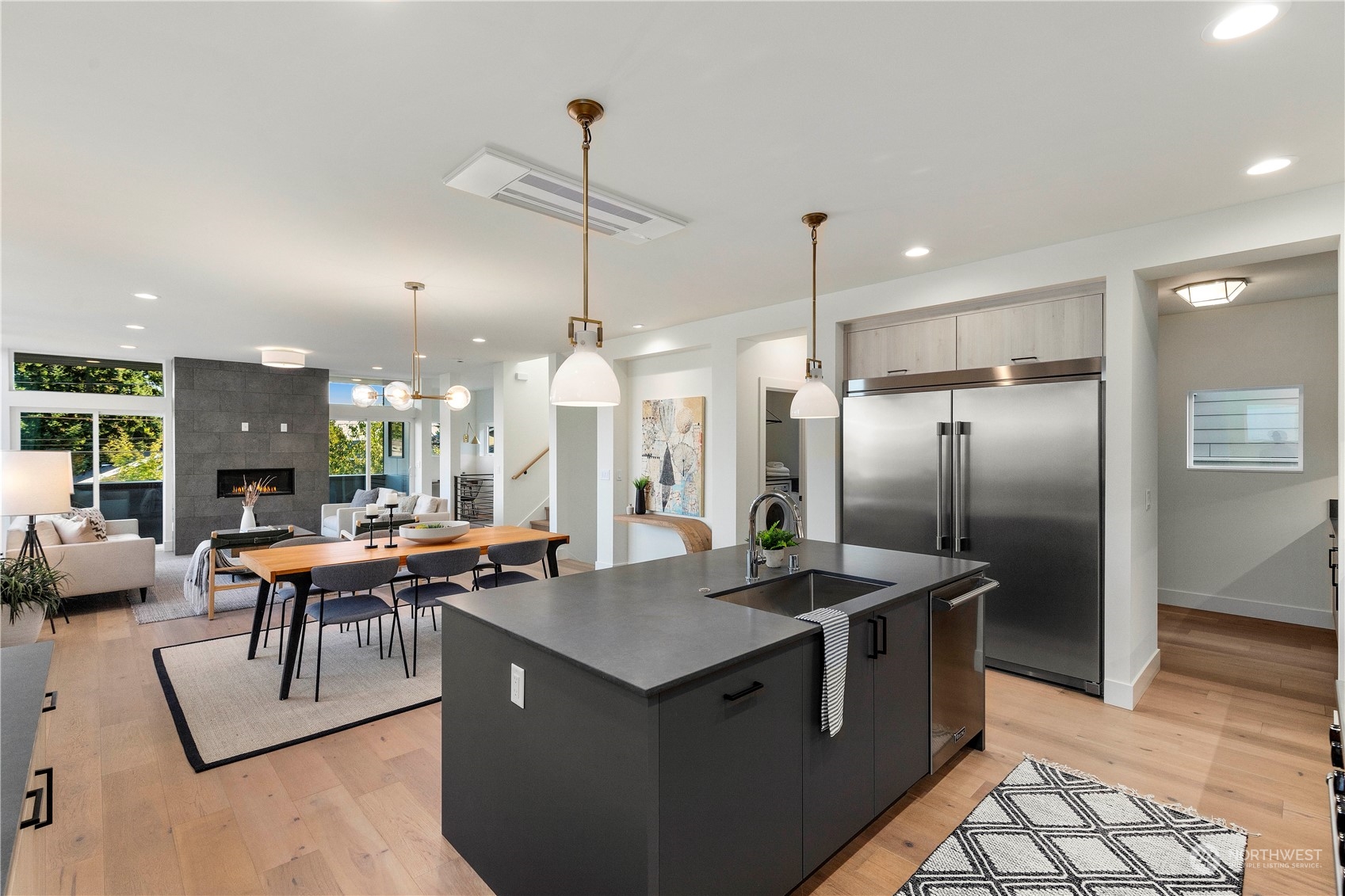 2308 North 38th Street Seattle, WA 98103 - Photo 9 of 40 a kitchen with stainless steel appliances granite countertop a sink a counter and chairs
