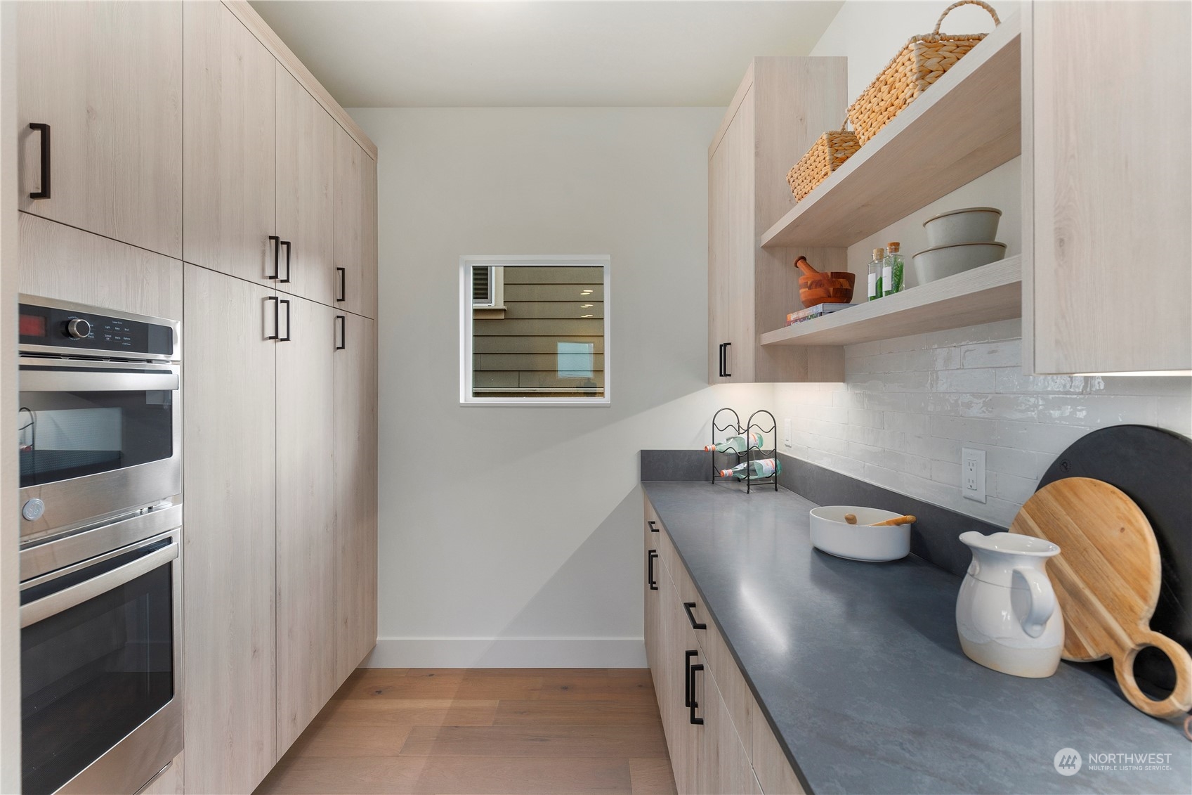 2308 North 38th Street Seattle, WA 98103 - Photo 10 of 40 a kitchen with stainless steel appliances a sink a stove and refrigerator
