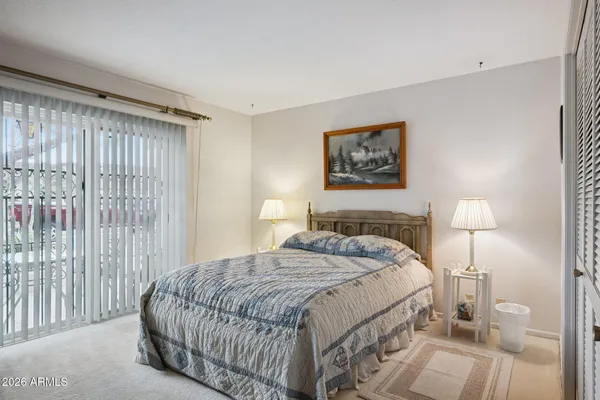 a bedroom with a bed and a night stand