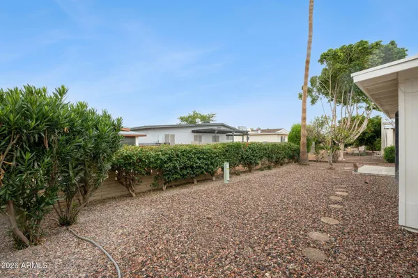a view of a garden with a building in the background
