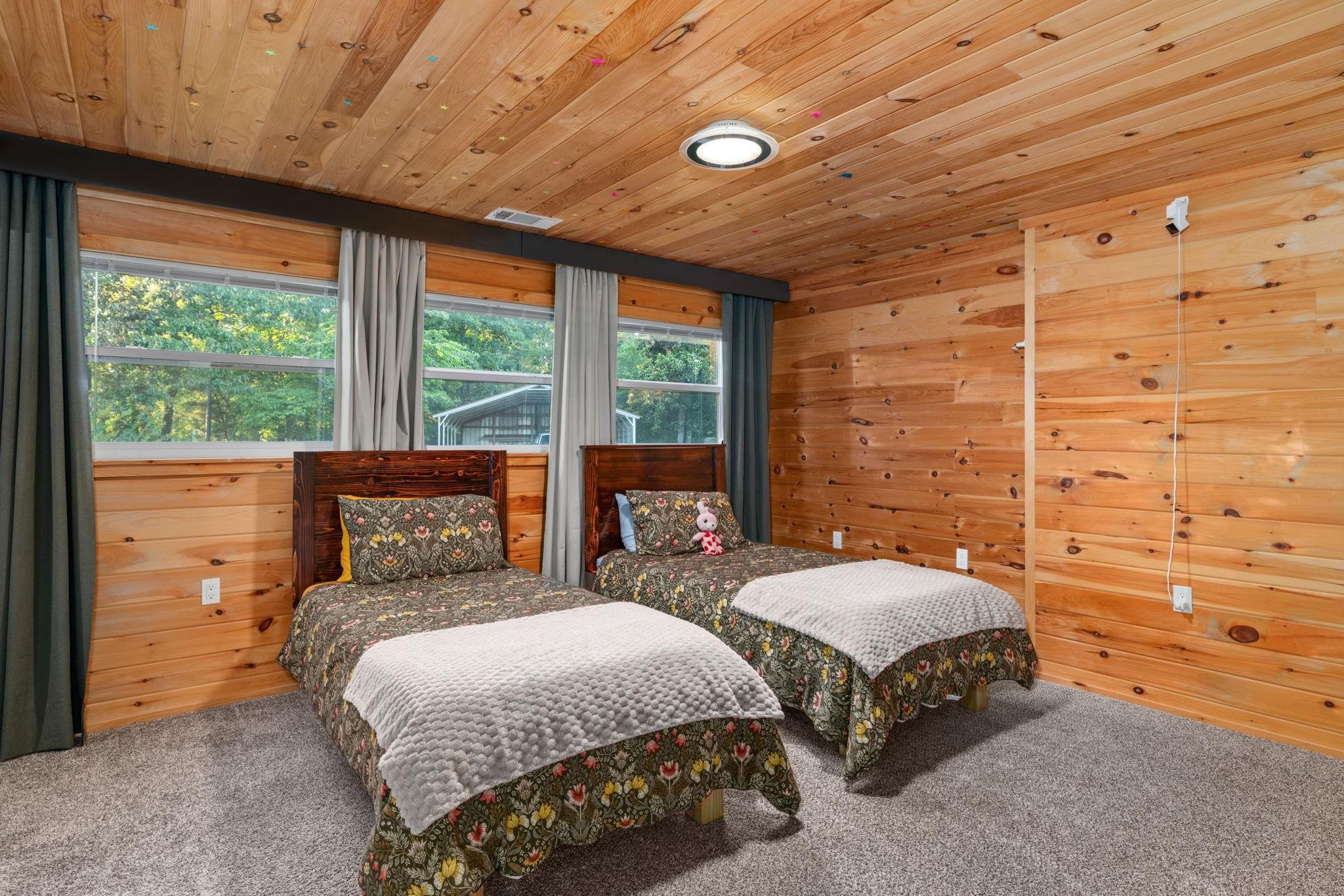 66 County Road 511 Corinth, MS 38834 - Photo 19 of 40 Interior room featuring wood-plank walls and ceiling, gray carpeting, and multiple windows with exterior views