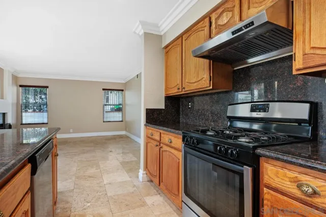 a kitchen with stainless steel appliances granite countertop a stove and a sink