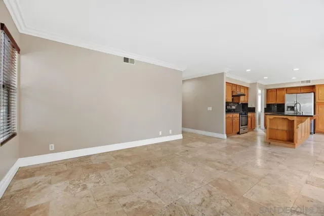 a view of a livingroom with furniture and an empty room