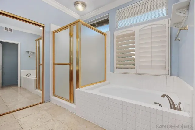 a bathroom with a bathtub and a shower