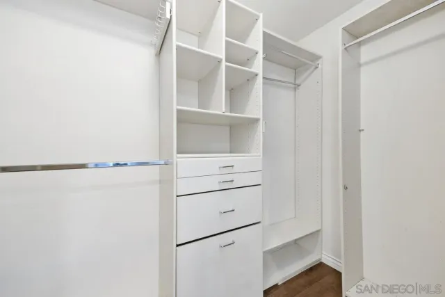 a view of walk in closet with empty racks