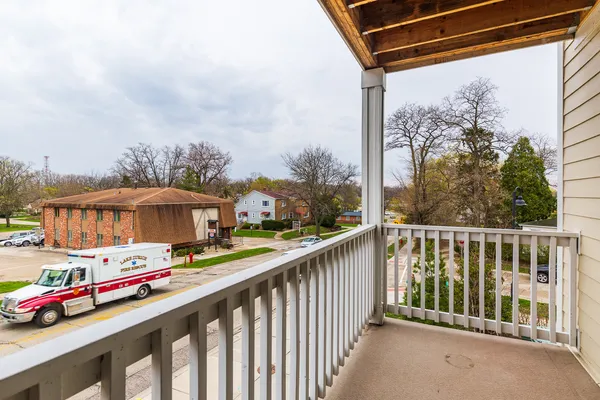 a balcony view with street view and car parked