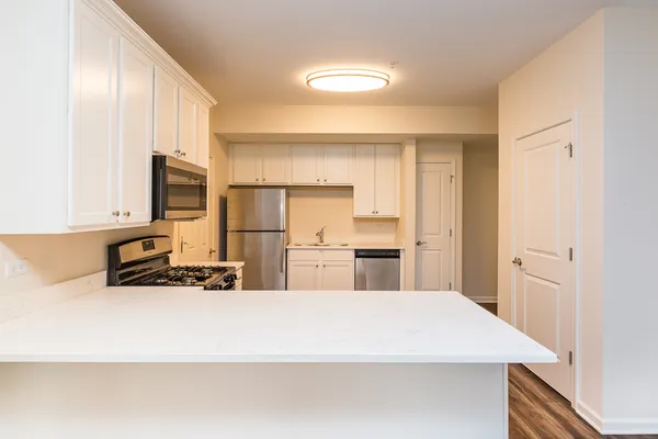 a kitchen with stainless steel appliances a refrigerator and microwave