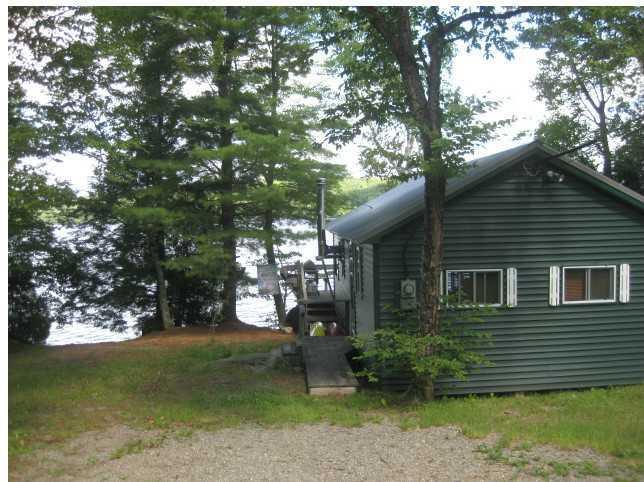 450 Stanhope Mill Road Lincoln, ME 04457 - Photo 8 of 31 Exterior Front. Metal roof and vinyl...