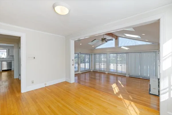wooden floor in an empty room with a window
