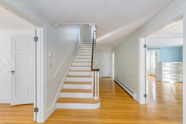 a view of entryway and hall with wooden floor