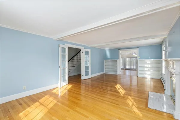 a view of empty room with wooden floor