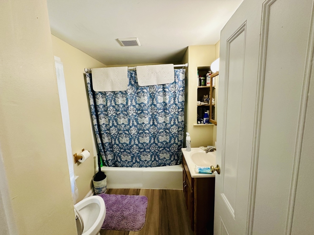 693 Concord Street Framingham, MA 01702 - Photo 9 of 19 a bathroom with a granite countertop sink and a mirror