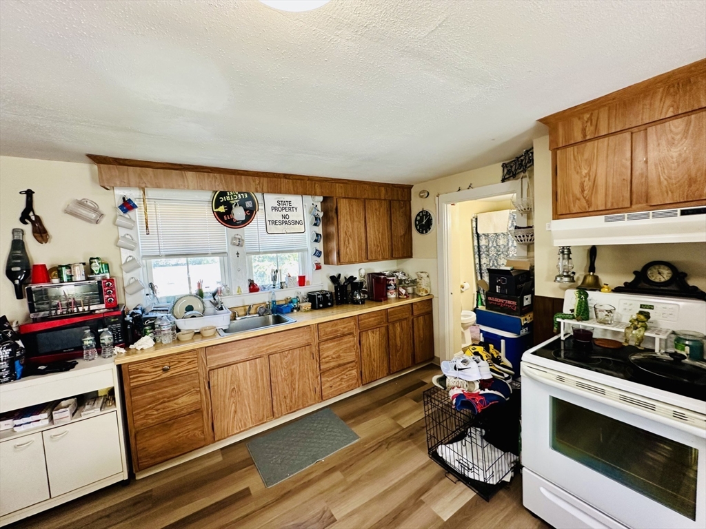 693 Concord Street Framingham, MA 01702 - Photo 10 of 19 a kitchen with a sink stove and cabinets