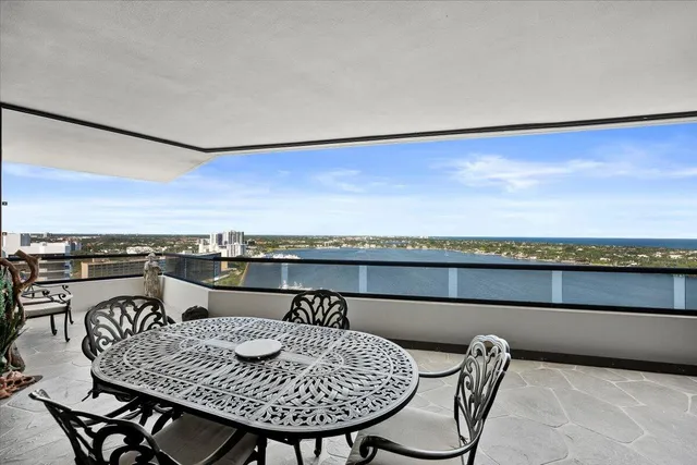 a view of a city from a dining room with furniture