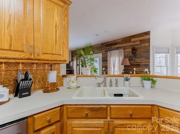 a kitchen with stainless steel appliances granite countertop a refrigerator a stove and a sink