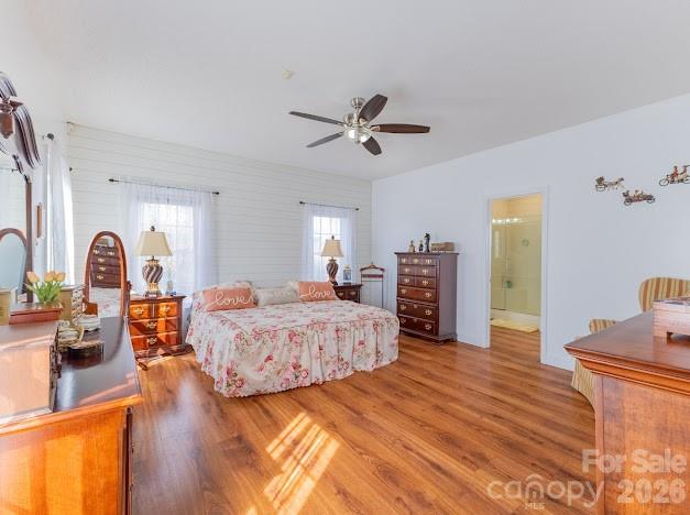 3131 Christie Road Hudson, NC 28638 - Photo 26 of 48 a spacious bedroom with a bed a dresser and wooden floor