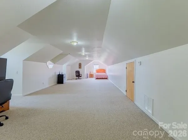 a bathroom with a sink toilet vanity and wooden floor